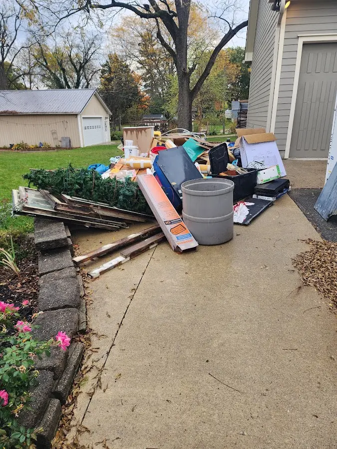 Dumpster being loaded with debris for 12 Yard Dumpster Rental in Gloucester